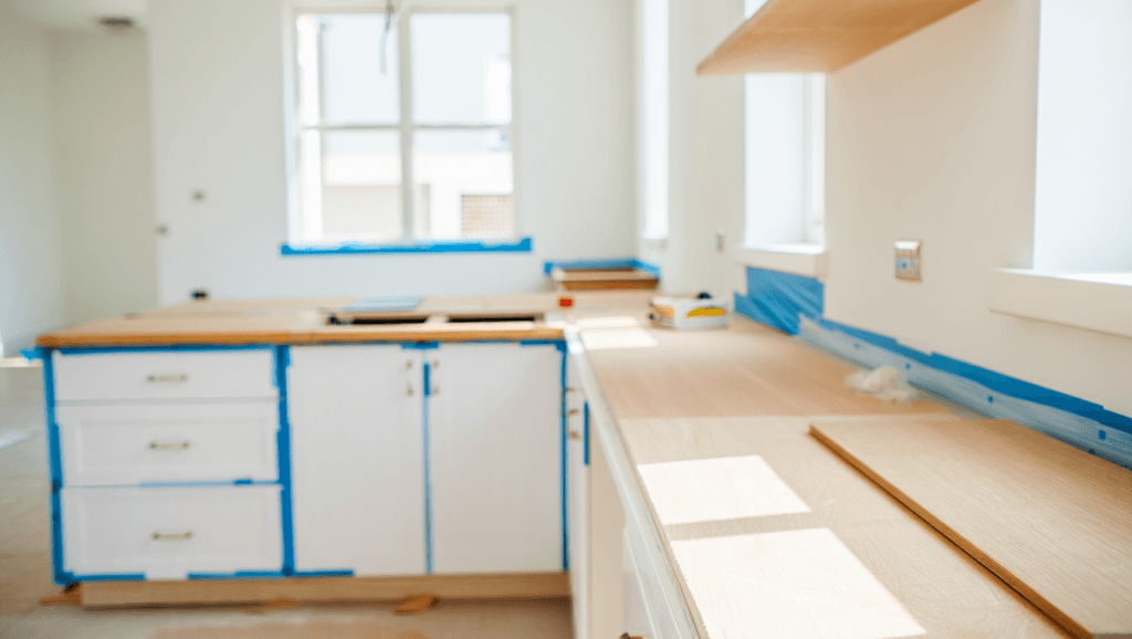 5 Signs Your Kitchen Cabinets Need Refinishing 4 A Utah kitchen mid-renovation with new quartz countertops and freshly refinished white cabinets.