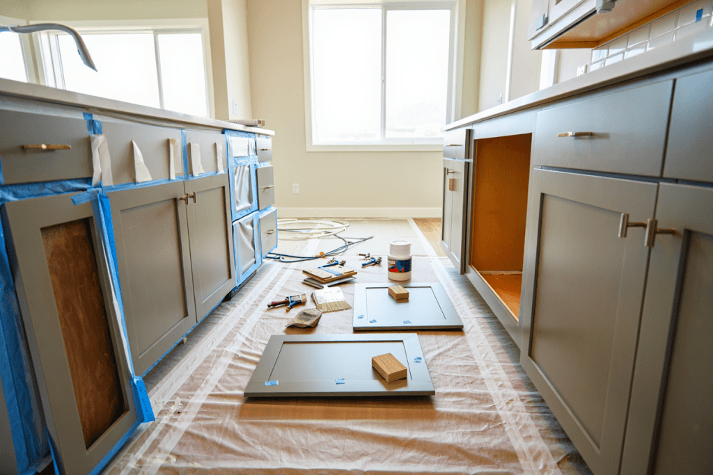 Labeled cabinet doors and drawer fronts prepared for professional cabinet painting in a modern Utah kitchen.
