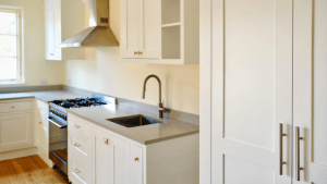 kitchen scene showing freshly refinished cabinets. Reface kitchen cabinets or repaint kitchen cabinets?