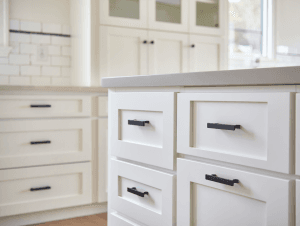 White painted kitchen cabinets with matte black handles and knobs in modern farmhouse style Utah home