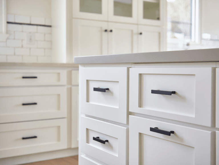 White painted kitchen cabinets with matte black handles and knobs in modern farmhouse style Utah home