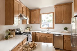 Can kitchen cabinets be restained? Restained solid oak cabinets with a satin finish in a Utah kitchen